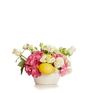 Floral arrangement with hydrangea, roses, lemons and lisianthus