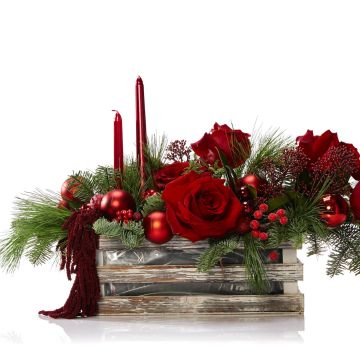 Floral arrangement with red roses, skimmia and globes