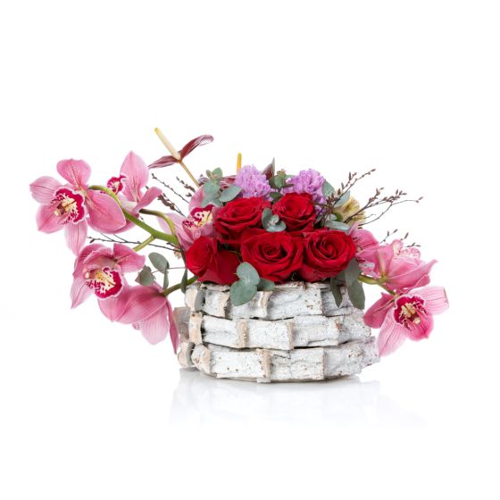 Floral arrangement in basket with pink cymbidium and hyacinths