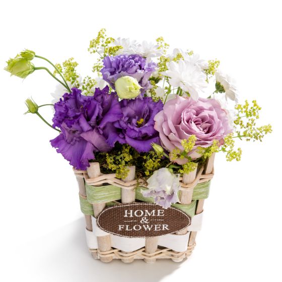 Floral arrangement in basket from rose, chrysanthemum, alchemilla