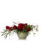 Floral arrangement in ceramic vase with red roses and skimmia