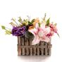 Floral arrangement in basket with purple lisianthus
