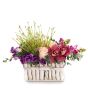Floral arrangement in basket with roses and purple lisianthus