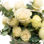 Floral arrangement in basket made of white roses, ruscus