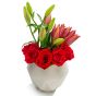 Business floral arrangement with lilies and red roses