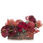 Floral arrangement in basket with anthurium grena and orchids