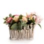 Floral arrangement in basket with pink roses and hypericum