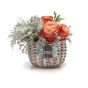 Floral arrangement in basket of roses and lisianthus