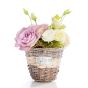 Floral arrangement in basket of purple roses, white lisianthus